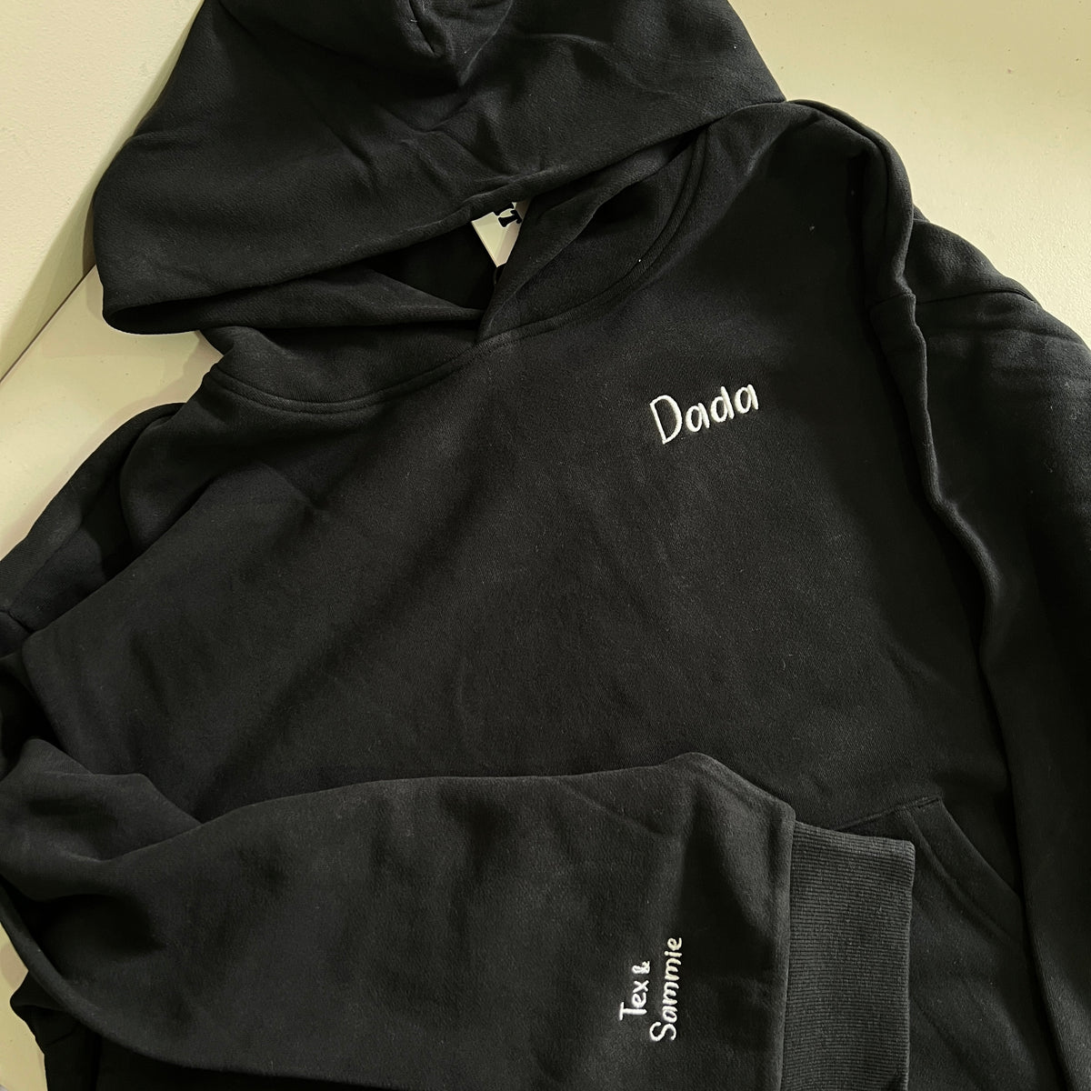Kid’s names and dada embroidered on a blak hoodie for father’s day 
