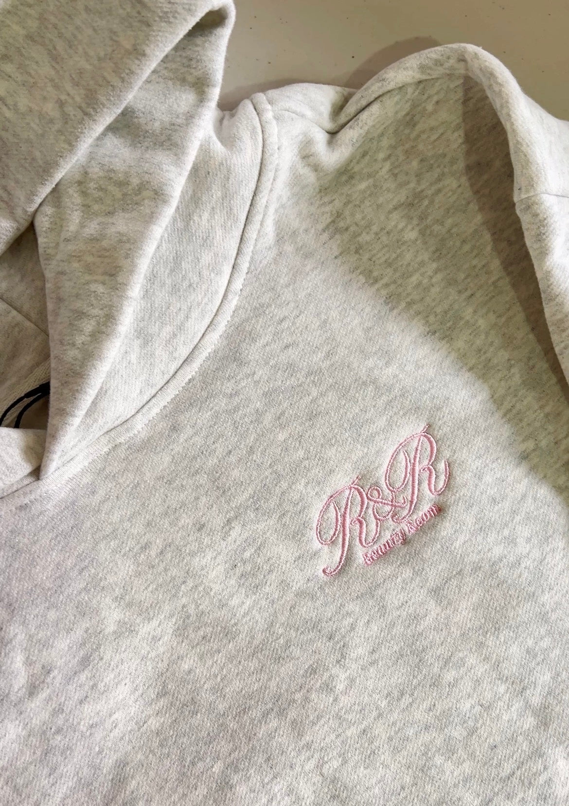 Left chest embroidery of a salon logo on a premium Heavyweight jumper in Melbourne 