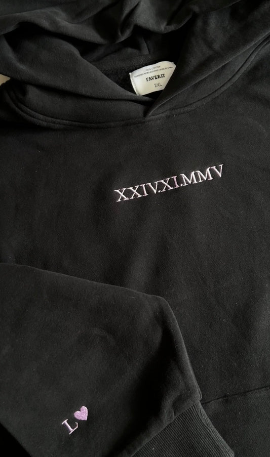 Centre chest embroidery of the birthday, anniversary or any special occasional date in roman numerals on a sweatshirt hoodie. A gift for partner on anniversary, valentines etc.