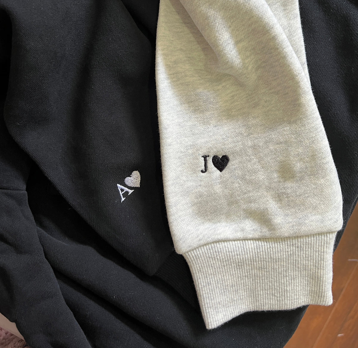 Couple hoodies with initials and heart embroidered on sleeves 